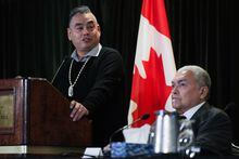 Former Tk'emlups te Secwepemc chief Shane Gottfriedson, left, speaks as hiwus (Chief) Warren Paull, of the Sechelt (shishalh) First Nation, listens during a news conference, in Vancouver, B.C., Saturday, Jan. 21, 2023. Scores of First Nations leaders are voicing their formal support in court for a $2.8-billion settlement agreement to a class-action residential schools lawsuit. THE CANADIAN PRESS/Darryl Dyck