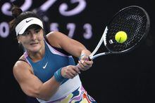 Bianca Andreescu of Canada plays a backhand return to Cristina Bucsa of Spain during their second round match at the Australian Open tennis championship in Melbourne, Australia, Wednesday, Jan. 18, 2023. (AP Photo/Ng Han Guan)