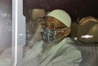 Islamic cleric Abu Bakar Bashir sits inside a van as he leaves Gunung Sindur Prison, in Bogor, West Java, Indonesia, on Jan. 8, 2021.