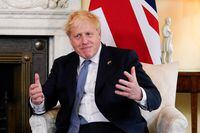 British Prime Minister Boris Johnson reacts during next to the Estonian Prime Minister during their meeting at 10 Downing Street, London, Britain June 6, 2022. Alberto Pezzali/Pool via REUTERS