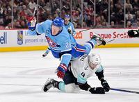 Jan 9, 2023; Montreal, Quebec, CAN; Montreal Canadiens forward Christian Dvorak (28) trips over Seattle Kraken defenseman Justin Schultz (4) during the second period at the Bell Centre. Mandatory Credit: Eric Bolte-USA TODAY Sports