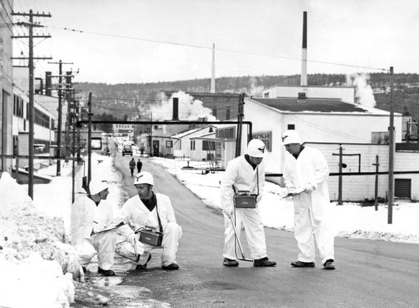 DETECTORS FIND SOURCE OF LEAK -- A team of white-clad specialists from the Royal Canadian Engineers are shown here on the job, December 18, 1952, at Chalk River helping to locate excessive radiation which escaped from the reactor at Canada's big Atomic Energy Plant on December 12, 1952. The 12-man team found the exact location and intensity of radiation contamination at the atomic energy plant, army headquarters announced today. Left to right are Sgt. G.E. Green, Regina; Spr. D.A. Miller, Cornwall, Ont.; Spr. T.B. Gorman, Halifax and Cpl. F.D. MacKenzie, Kentville, N.S. (CP from National Defence)