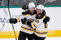 Boston Bruins' Pavel Zacha (18) and David Pastrnak (88) celebrate after Zacha scored in the third period of an NHL hockey game against the Dallas Stars, Tuesday, Feb. 14, 2023, in Dallas. The Bruins top the overall standings with an impressive 40-8-5 record – good for a 62-win, 132-point pace. THE CANADIAN PRESS/APTony Gutierrez