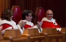 Supreme Court Justice Russell Brown, right, is applauded by Justice Clement Gascon, centre, and Justice Andromache Karakatsanis during an official welcoming ceremony at the Supreme Court of Canada in Ottawa, Tuesday October 6, 2015. THE CANADIAN PRESS/Adrian Wyld