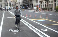 A man rides a bicycle as Milan reallocates road space previously used by cars to new bicycle lanes and pedestrian pathways, as part of an effort to reduce pollution ahead of lockdown gradually lifting due to a spread of the coronavirus disease (COVID-19), in Milan, Italy April 30, 2020. REUTERS/Daniele Mascolo
