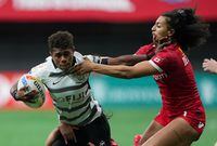 Fiji's Reapi Ulunisau, left, fights off Canada's Olivia De Couvreur during HSBC Canada Sevens women's rugby action, in Vancouver, on Sunday, March 4, 2023. THE CANADIAN PRESS/Darryl Dyck