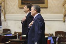 South Carolina Rep. John McCravy, R-Greenwood, foreground, and Rep. Max Hyde, R-Spartanburg, background, say the Pledge of Allegiance as the House session begins on Thursday, May 11, 2023, in Columbia, S.C. (AP Photo/Jeffrey Collins)