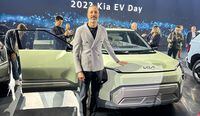 Karim Habib, head of Kia global design, stands with his hand on the Concept EV3 during the 2023 Kia EV Day in Seoul.