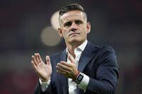 Canada's head coach John Herdman applauds at the end of the World Cup group F soccer match between Belgium and Canada, at the Ahmad Bin Ali Stadium in Doha, Qatar, Nov. 23, 2022. Herdman says he will remain as Canada's men's soccer coach. The 47-year-old Briton coached Canada in its first men's World Cup appearance since 1986. “Success at this level will always invite opportunity,” Herdman said in a statement on Wednesday, Feb. 1, 2023. (AP Photo/Natacha Pisarenko, file)