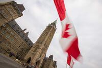 (FILES) In this file photo a Canadian flag flies in front of the peace tower on Parliament Hill in Ottawa, Canada on December 4, 2015. - The Canadian economy contracted by an annualized rate of 1.1 percent in the second quarter, after having roared back from a pandemic downturn in previous months, the national statistical agency said on August 31, 2021. Economists were expecting continued growth, but increases in business and government spending, according to Statistics Canada, were insufficient to offset a decline in exports and a slowdown in housing resales. (Photo by GEOFF ROBINS / AFP) (Photo by GEOFF ROBINS/AFP via Getty Images)