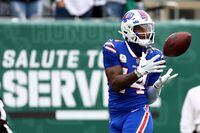 EAST RUTHERFORD, NEW JERSEY - NOVEMBER 06: Stefon Diggs #14 of the Buffalo Bills makes a catch for a first down in the first quarter of a game against the New York Jets at MetLife Stadium on November 06, 2022 in East Rutherford, New Jersey. (Photo by Elsa/Getty Images)