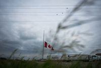 A Canadian flag flies at half-mast at a truck stop in Brandon, Man., on Friday, June 16, 2023, to honour the victims of a bus crash in Carberry, on the Trans-Canada Highway west of Winnipeg. Health authorities say six of 10 seniors who survived a bus crash in southern Manitoba that killed 15 others were listed in critical condition in hospital. THE CANADIAN PRESS/Darryl Dyck