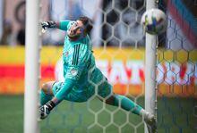 Toronto FC goalkeeper Alex Bono allows a goal to Vancouver Whitecaps' Brian White during the first half of the Canadian Championship soccer final, in Vancouver, on Tuesday, July 26, 2022. THE CANADIAN PRESS/Darryl Dyck