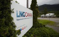 A truck drives past LNG Canada signage in Kitimat, B.C. on June 5, 2015.