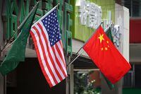 (FILES) In this file photo taken on May 14, 2019 The US (L) and Chinese flags are displayed outside a hotel in Beijing. - American tariffs on hundreds of billions of dollars of Chinese imports are due to expire in July, but could be extended if enough industries ask for it, US officials said May 3, 2022. (Photo by Greg Baker / AFP) (Photo by GREG BAKER/AFP via Getty Images)