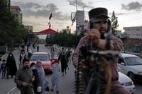 Taliban fighters stand guard in the Shiite neighborhood of Dasht-e-Barchi, in Kabul, Afghanistan, Aug. 7, 2022. (AP Photo/Ebrahim Noroozi)
