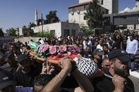 Mourners carry the body of Qusai Matan, 19, during his funeral in the West Bank city of Ramallah, Saturday, Aug. 5, 2023. On Friday the Palestinian Health Ministry said that armed Israeli settlers had entered the West Bank village of Burqa and shot and killed 19-year-old Qusai Matan. The Israeli military said it had received reports that Matan died as a result of settlers shooting toward Palestinians in the village and said it's investigating. (AP Photo/Nasser Nasser)