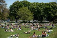 People sit and lie in the sun at Kitsilano Beach Park in Vancouver, on Saturday, May 9, 2020. The Vancouver Park Board has voted in favour of a pilot project that would allow the sale of beer, cider and coolers in 22 of Vancouver's 240 parks. THE CANADIAN PRESS/Darryl Dyck
