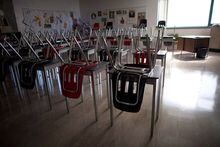 Vacant desks are pictured at the front of an empty classroom at McGee Secondary school in Vancouver on Sept. 5, 2014. The Manitoba government is trying for a second time to reform education in the province, but this time without planning to eliminate elected school boards. THE CANADIAN PRESS/Jonathan Hayward