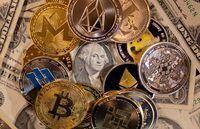 FILE PHOTO: Representations of virtual cryptocurrencies are placed on U.S. Dollar banknotes in this illustration taken November 28, 2021. REUTERS/Dado Ruvic/Illustration/File Photo