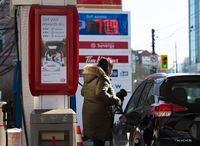 A women fills her vehicle with gas as prices dropped overnight in Toronto on Wednesday, March 18, 2020. THE CANADIAN PRESS/Nathan Denette