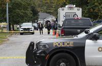 Police and SIU investigators gather at the scene where two police officers were killed in Innisfil, Ont., on Wednesday, Oct. 12, 2022. THE CANADIAN PRESS/Arlyn McAdorey
