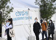 People wait in line at a COVID assessment centre at Women's College Hospital on Wednesday, September 23, 2020. Nearly 1,000 confirmed cases of a new sublineage of the Omicron variant have been discovered in Ontario, but experts say it doesn't warrant significant concern.THE CANADIAN PRESS/Nathan Denette