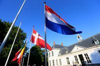 FILE PHOTO: Flags of the Netherlands and Denmark are seen as a meeting to prepare for the upcoming Madrid summit of the alliance is held, in The Hague, Netherlands June 14, 2022. REUTERS/Eva Plevier