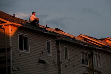 A man surveys the damage left after a tornado touched down in his neighbourhood, in Barrie, Ont., on Thurs., July 15, 2021. THE CANADIAN PRESS/Christopher Katsarov