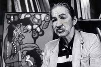 Indigenous artist Norval Morrisseau says he is heppy sketching in the streets of Vancouver as he poses in front of one of his earlier paintings at a Vancouver gallery on Monday, May 11, 1987. The OPP say they have been investigating alleged fraudulent art that is being made and sold under Morrisseau's name. THE CANADIAN PRESS/Chuck Stoody
