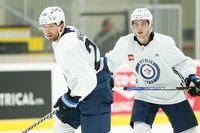 Winnipeg Jets' Blake Wheeler (26) and Ville Heinola (14) look down ice during opening day of their NHL training camp practice in Winnipeg, Thursday, Sept. 22, 2022. THE CANADIAN PRESS/John Woods