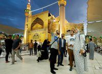 Anna Nikolaevna, 38, a Russian national, and Jacob Nemec, 29, an American national, look on during a tour at Imam Ali shrine, in the holy city of Najaf, Iraq June 5, 2023.  REUTERS/Alaa Al-Marjani