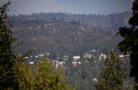 <div>The Central Okanagan Regional Operations centre says residents of 16 properties along Bear Creek Road are allowed to go home, although they remain on evacuation alert and must be ready to leave again if the McDougall Creek wildfire flares again. Burned trees are seen above a neighbourhood in West Kelowna, B.C. during a visit by Prime Minister Justin Trudeau in West Kelowna, B.C., Friday, Aug. 25, 2023. THE CANADIAN PRESS/Marissa Tiel</div>