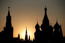 FILE PHOTO: The sun sets behind the Kremlin's Spasskaya Tower and St. Basil's Cathedral during the soccer World Cup in Moscow, Russia June 18, 2018. REUTERS/Christian Hartmann/File Photo