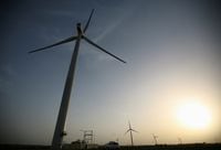FILE PHOTO: Power generating windmill turbines are pictured during the inauguration ceremony of the new 25 MW ReNew Power wind farm at Kalasar village in the western Indian state of Gujarat May 6, 2012. REUTERS/Amit Dave (INDIA - Tags: ENERGY BUSINESS)