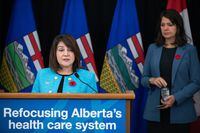 Adriana LaGrange, minister of health, speaks about health-care reforms as Alberta Premier Danielle Smith looks on during a news conference in Edmonton on Wednesday Nov. 8, 2023. The board of Alberta Health Services says six of the organization's top executives are no longer in their positions. THE CANADIAN PRESS/Jason Franson