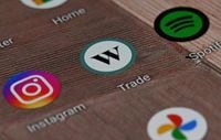 A Wealthsimple Trade app icon is shown on a smartphone on Tuesday, Dec. 15, 2020. Some stock trading platforms say usership has spiked in 2020, as a whipsawing stock market and more time at home has Canadians day trading. THE CANADIAN PRESS/Jesse Johnston