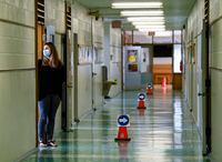 Grade two teacher Vivian Mavraidis looks out into the hallways at Hunter's Glen Junior Public School during the COVID-19 pandemic in Scarborough, Ont., on Sept. 14, 2020.