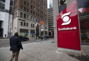 A large sign for Scotiabank stands on the sidewalk at Queen St. West and Bay St. on April 12, 2022. Fred Lum/The Globe and Mail.