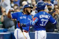 TORONTO, ON - SEPTEMBER 13: Vladimir Guerrero Jr. #27 of the Toronto Blue Jays celebrates with Teoscar Hernandez #37 as he scores his 45th home run of the season, in the sixth inning of their MLB game against the Tampa Bay Rays at Rogers Centre on September 13, 2021 in Toronto, Ontario. (Photo by Cole Burston/Getty Images)