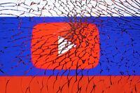 FILE PHOTO: Youtube logo and Russian flag are seen through broken glass in this illustration taken March 1, 2022. REUTERS/Dado Ruvic/Illustration/File Photo