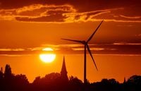 FILE PHOTO: A power-generating windmill turbine is pictured during sunset at a renewable energy park in Ecoust-Saint-Mein, France, September 6, 2020. REUTERS/Pascal Rossignol