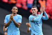 Manchester City's English midfielder Phil Foden (R) and Manchester City's Swiss defender Manuel Akanji applauds the fans following the English FA Cup semi-final football match between Manchester City and Sheffield United at Wembley Stadium in north west London on April 22, 2023. - Manchester City won the match 3-0. (Photo by Glyn KIRK / AFP) / NOT FOR MARKETING OR ADVERTISING USE / RESTRICTED TO EDITORIAL USE (Photo by GLYN KIRK/AFP via Getty Images)
