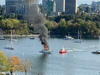 A pleasure craft burns in Vancouver's False Creek Thursday, Sept. 7, 2023. Vancouver Fire and Rescue says a man may have been cooking when the fire broke out in the waters off David Lam Park in Yaletown. THE CANADIAN PRESS/Beth Leighton