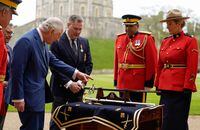 King Charles III is presented with a sword as he formally accepts the role of Commissioner-in-Chief of the Royal Canadian Mounted Police (RCMP) during a ceremony in the quadrangle at Windsor Castle, Berkshire, Britain Picture date: Friday April 28, 2023. Andrew Matthews/Pool via REUTERS