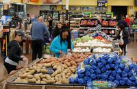 FILE - In this Nov. 27, 2019, file photo people shop for food the day before the Thanksgiving holiday at a Walmart Supercenter in Las Vegas. U.S. consumer prices increased slightly last month, driven higher by more expensive food. The Labor Department said Wednesday, March 11, 2020, that the consumer price index ticked up 0.1% last month, matching its January increase. (AP Photo/John Locher, File)