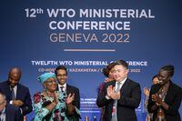 World Trade Organization Director-General Ngozi Okonjo-Iweala claps next to conference chair Timur Suleimenov after a closing session of a World Trade Organization Ministerial Conference at the WTO headquarters in Geneva, Switzerland June 17, 2022. Fabrice Coffrini/Pool via REUTERS