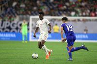 FILE PHOTO: Jun 29, 2019; Houston, TX, USA; Canada midfielder Alphonso Davies (12) dribbles against Haiti midfielder Steeven Saba (19) in the second half of quarterfinal play in the CONCACAF Gold Cup soccer tournament at NRG Stadium. Mandatory Credit: Thomas B. Shea-USA TODAY Sports/File Photo