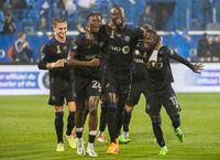 CF Montreal’s Kei Kamara, centre, celebrates with teammates after scoring against Chicago Fire during first half MLS soccer action in Montreal, Tuesday, September 13, 2022. With CF Montreal’s rain-soaked win over Chicago on Tuesday evening at Stade Saputo, the club has done enough to secure home field advantage for the first round of the Major League Soccer Playoffs. THE CANADIAN PRESS/Graham Hughes