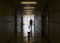A teacher walks in the hall of a public school in Scarborough, Ont., on Monday, September 14, 2020. THE CANADIAN PRESS/Nathan Denette